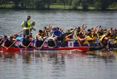 Michele Stowe of Skyrocket Coaching acting as the drummer on a dragon boat