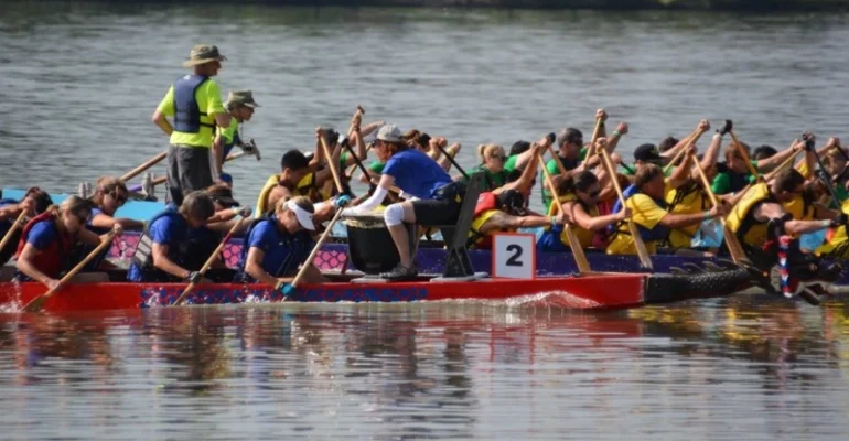 Michele Stowe of Skyrocket Coaching acting as the drummer on a dragon boat